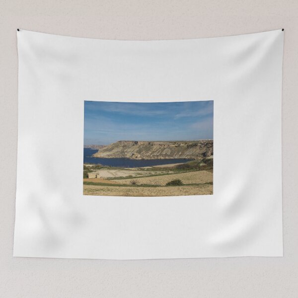 Item preview, Rocky Coastal Cliffs Overlooking A Calm Blue Bay With Farmland And Clear Sky designed and sold by Nmallia.
