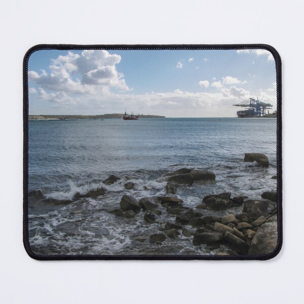 Item preview, Calm Rocky Shoreline Overlooking Cargo Ship and Industrial Port Under Cloudy Sky designed and sold by Nmallia.