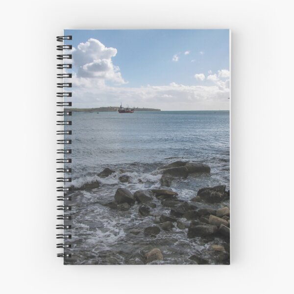 Item preview, Calm Rocky Shoreline Overlooking Cargo Ship and Industrial Port Under Cloudy Sky designed and sold by Nmallia.