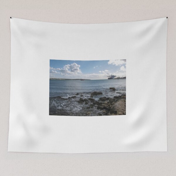 Item preview, Calm Rocky Shoreline Overlooking Cargo Ship and Industrial Port Under Cloudy Sky designed and sold by Nmallia.
