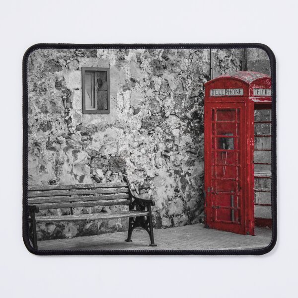 Item preview, Red Telephone Box and Empty Bench Against Weathered Stone Wall in Selective Color Photograph designed and sold by Nmallia.
