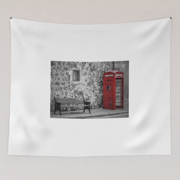 Item preview, Red Telephone Box and Empty Bench Against Weathered Stone Wall in Selective Color Photograph designed and sold by Nmallia.