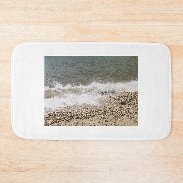 Item preview, Pebble Beach Shoreline With Breaking Waves and Rocky Coastline On A Calm Sea designed and sold by Nmallia.