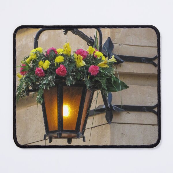Item preview, Vintage Wall Lantern With Bright Floral Arrangement Hanging On A Stone Street Corner designed and sold by Nmallia.