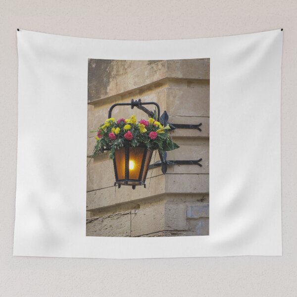 Item preview, Vintage Wall Lantern With Bright Floral Arrangement Hanging On A Stone Street Corner designed and sold by Nmallia.