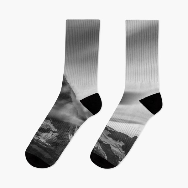 Item preview, Snowcapped Matterhorn peak in the clouds at sunrise, Zermatt, Switzerland black and white photographic art print designed and sold by Astrid Arkhangelsky.