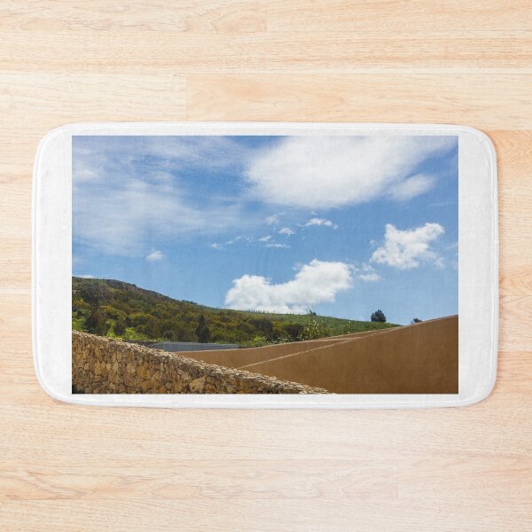 Item preview, Stone Wall and Terraced Hillside Under Bright Blue Sky With Fluffy White Clouds designed and sold by Nmallia.