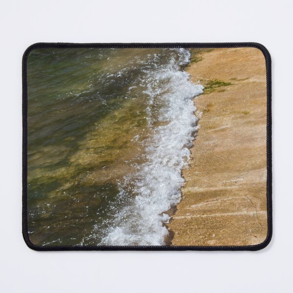 Item preview, Gentle Wave Lapping Against Rocky Shore With Sea Foam and Algae on Sunlit Coastline designed and sold by Nmallia.