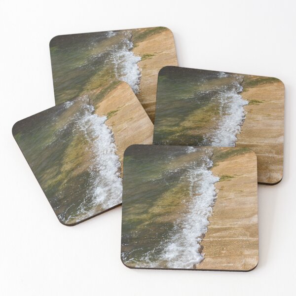 Item preview, Gentle Wave Lapping Against Rocky Shore With Sea Foam and Algae on Sunlit Coastline designed and sold by Nmallia.