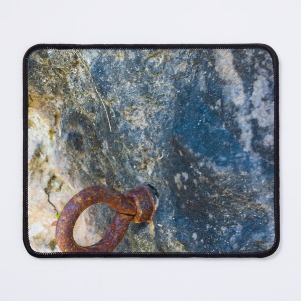 Item preview, Rusty Iron Ring Bolt Anchored in Weathered Rock Surface With Textured Stone Background designed and sold by Nmallia.