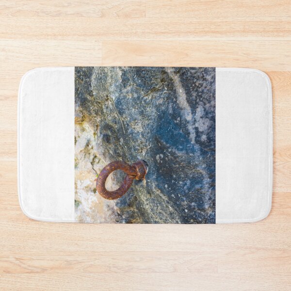 Item preview, Rusty Iron Ring Bolt Anchored in Weathered Rock Surface With Textured Stone Background designed and sold by Nmallia.