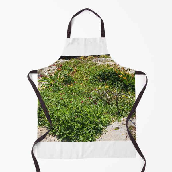 Item preview, Coastal Wildflowers On A Rocky Shore With Lush Green Vegetation And Sunlit Rocks designed and sold by Nmallia.