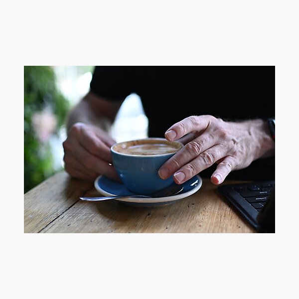 Item preview, Man Holding Cappuccino at Restaurant designed and sold by getmybookstore.