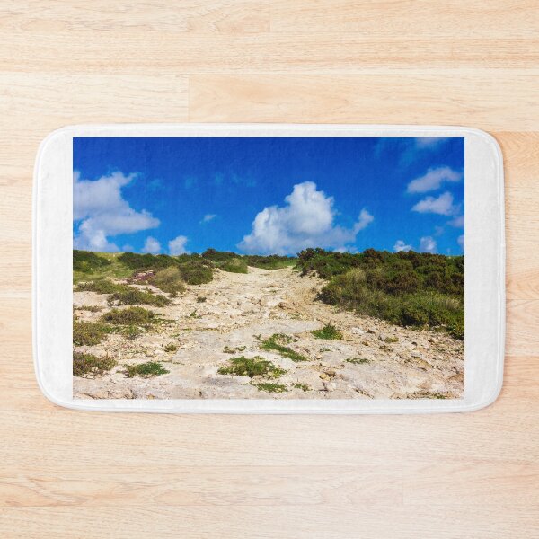 Item preview, Rocky Coastal Path Leading Up Through Scrubland Under A Bright Blue Sky With Puffy Clouds designed and sold by Nmallia.