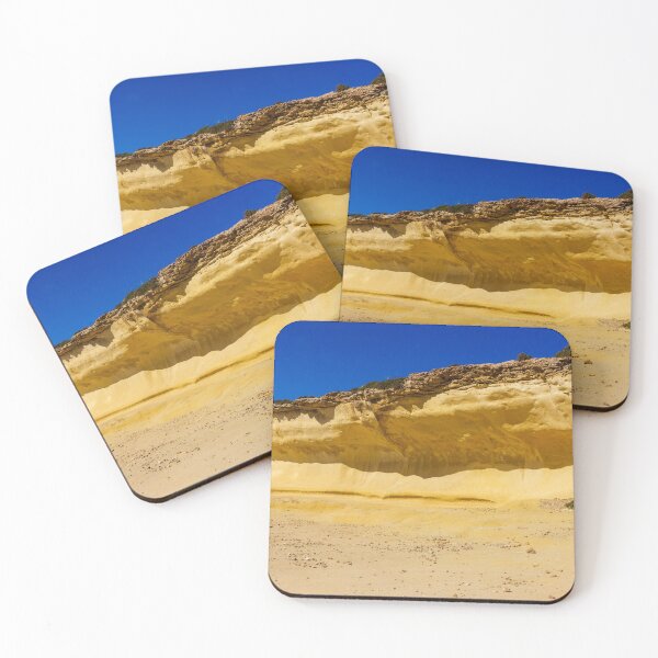 Item preview, Golden Sandstone Cliff On Coastal Beach With Clear Blue Sky And Sparse Vegetation designed and sold by Nmallia.