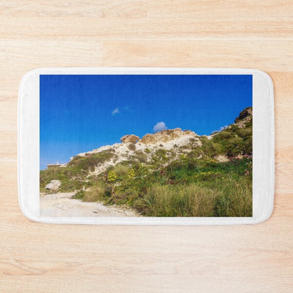 Item preview, Rocky Coastal Path Leading Up Through Scrubland Under A Bright Blue Sky With Puffy Clouds designed and sold by Nmallia.