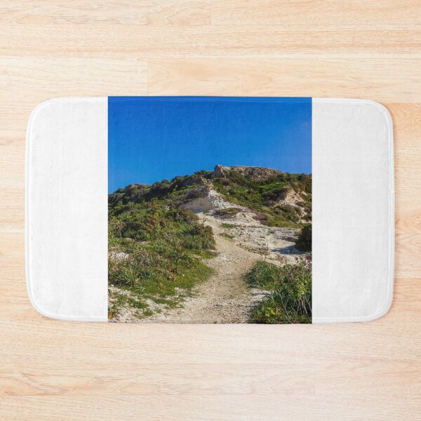 Item preview, Rocky Coastal Path Leading Up Through Scrubland Under A Bright Blue Sky With Puffy Clouds designed and sold by Nmallia.