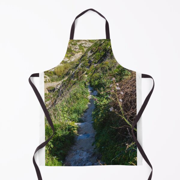 Item preview, Narrow Rocky Path Along Green Hillside With Wildflowers and Old Stone Bridge in Sunlight designed and sold by Nmallia.