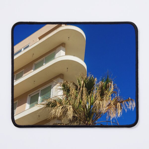 Item preview, Modern Apartment Building With Curved Balconies and Palm Tree Against Deep Blue Sky designed and sold by Nmallia.