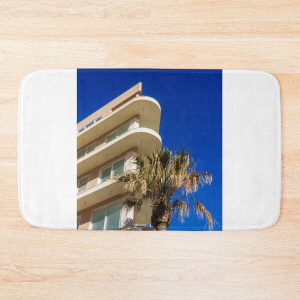 Item preview, Modern Apartment Building With Curved Balconies and Palm Tree Against Deep Blue Sky designed and sold by Nmallia.