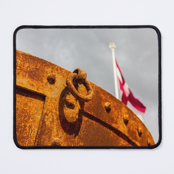 Item preview, Rusty Metal Hull With Heavy Ring Detail and Blurred Flagpole Against Stormy Sky designed and sold by Nmallia.