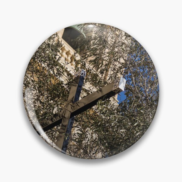 Item preview, Wooden Cross and Olive Tree in Front of Historic Church Bell Tower Against Blue Sky designed and sold by Nmallia.