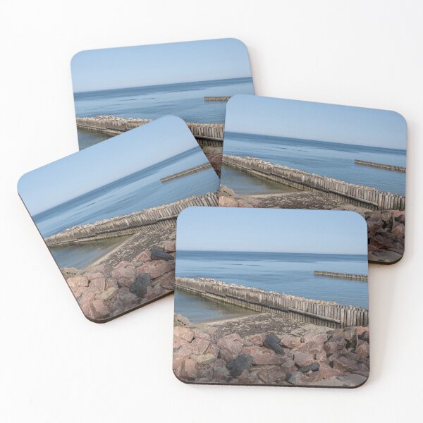 Item preview, Calm Sea with Wooden Breakwaters and Rocky Shoreline designed and sold by VisualMoodFoto.