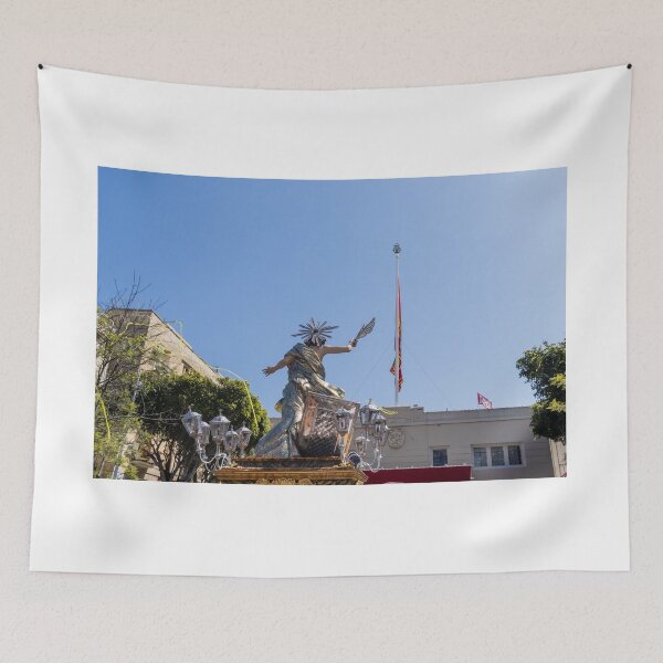 Item preview, Religious Procession Statue On Ornate Float With Spanish Flag Against Clear Blue Sky designed and sold by Nmallia.