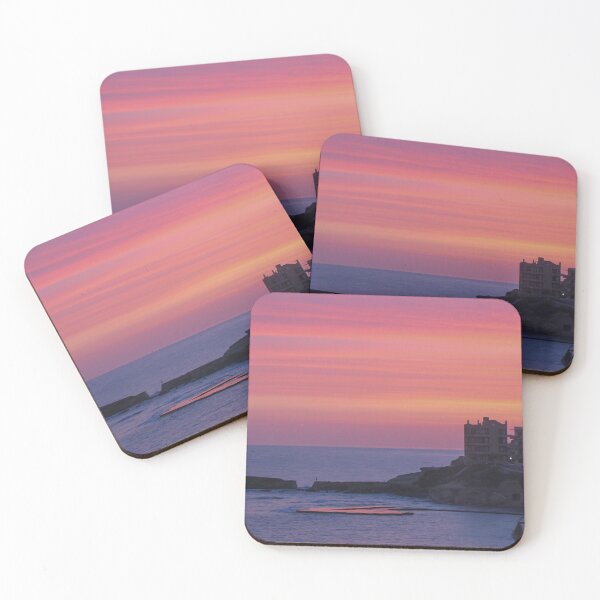 Item preview, Pink Sunset Over Coastal Town With Sea View and Cliffside Buildings at Dusk designed and sold by Nmallia.
