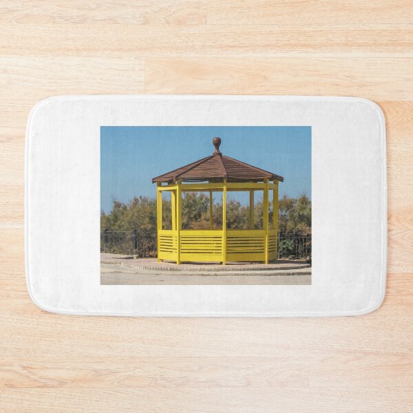 Item preview, Yellow Wooden Gazebo Pavilion On Seafront Promenade With Brown Roof And Blue Sky designed and sold by Nmallia.