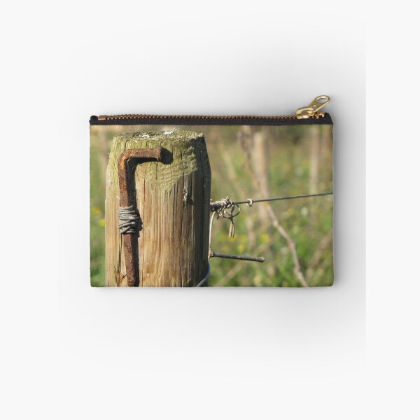 Item preview, Rusty Nail and Barbed Wire On Weathered Wooden Fence Post in Sunny Rural Countryside Close-Up designed and sold by Nmallia.
