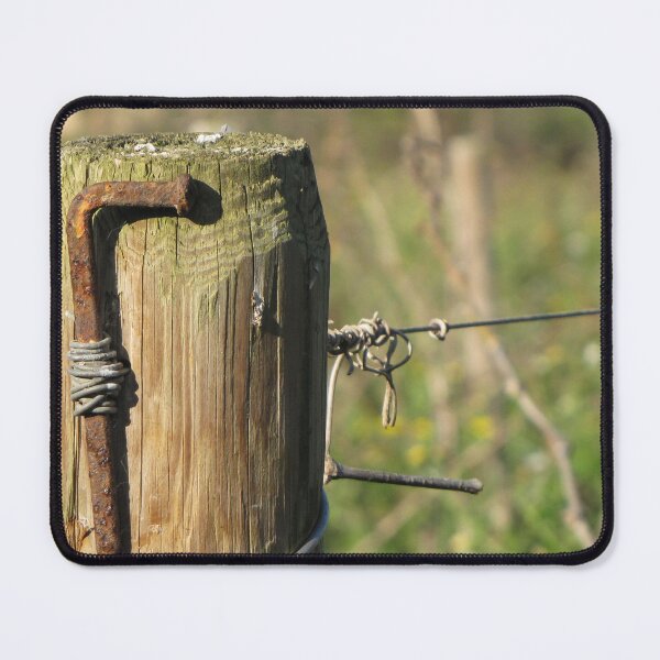 Item preview, Rusty Nail and Barbed Wire On Weathered Wooden Fence Post in Sunny Rural Countryside Close-Up designed and sold by Nmallia.