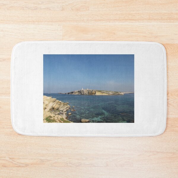 Item preview, Rocky Coastal Island With Statue Over Clear Blue Mediterranean Sea On Sunny Day designed and sold by Nmallia.