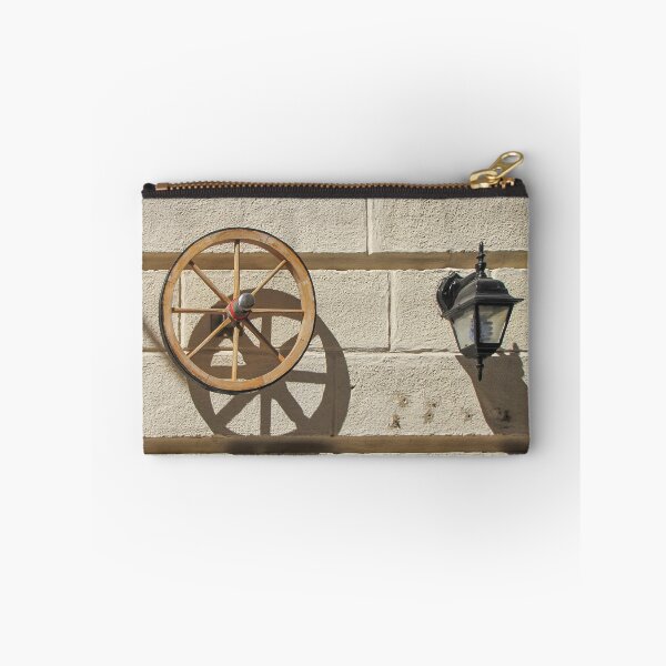 Item preview, Vintage Wooden Wheel and Lantern Mounted on Sunlit Stone Wall Casting Strong Shadow designed and sold by Nmallia.