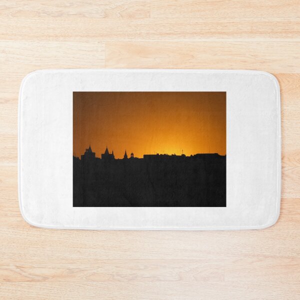Item preview, City Skyline Silhouette At Orange Sunset With Historic Rooftops And Church Spires Against Sky designed and sold by Nmallia.