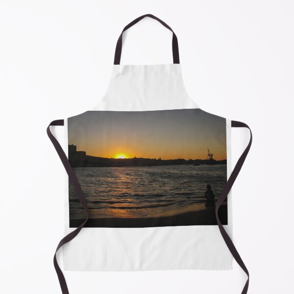 Item preview, Sunset Over Harbor Beach With Silhouette Child Sitting on Shore and City Skyline Beyond designed and sold by Nmallia.