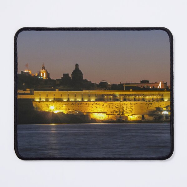Item preview, Illuminated Coastal Fortress at Dusk Over Calm Harbor Water With Historic City Silhouette designed and sold by Nmallia.
