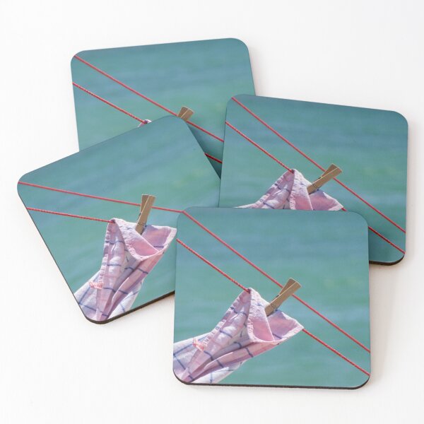 Item preview, Clothespin Holding Pink Towel On Red Clothesline Against Turquoise Seaside Background In Summer Light designed and sold by Nmallia.
