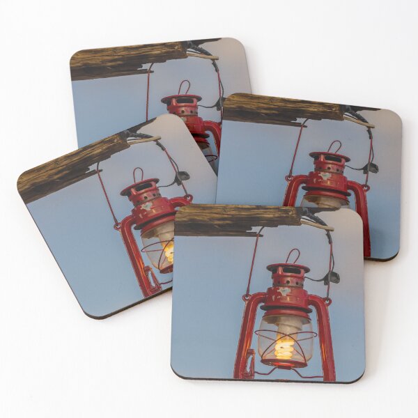 Item preview, Red Vintage Lantern Hanging From Weathered Wood With Warm Glowing Bulb At Dusk designed and sold by Nmallia.