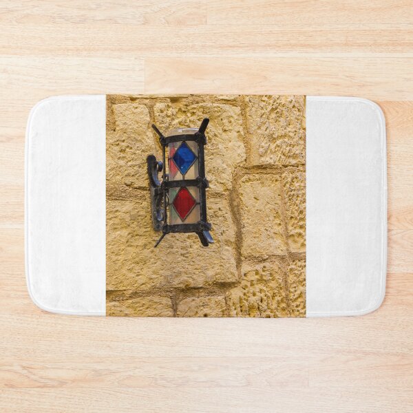 Item preview, Vintage Stained Glass Wall Lantern Mounted On Weathered Stone Wall In Sunny Alleyway designed and sold by Nmallia.
