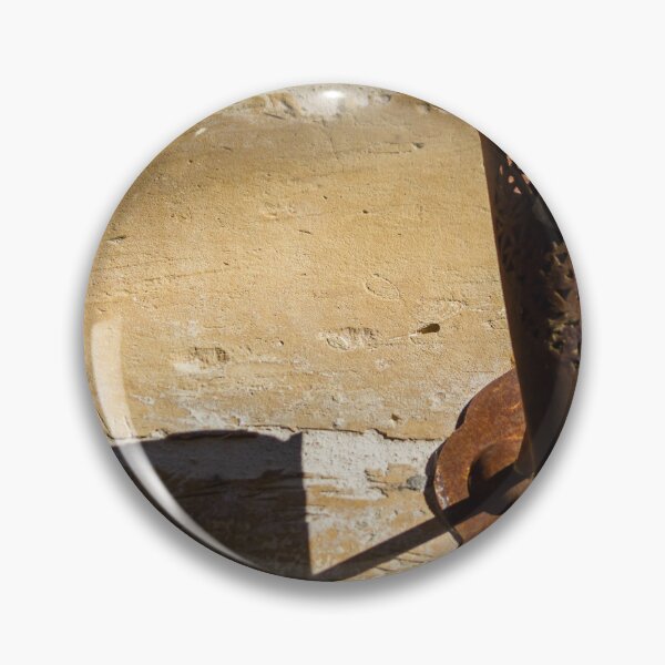 Item preview, Rusted Decorative Metal Sconce Casting a Sharp Shadow on Sunlit Stone Wall, Vintage Rustic Texture designed and sold by Nmallia.