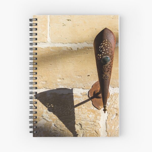 Item preview, Rusted Decorative Metal Sconce Casting a Sharp Shadow on Sunlit Stone Wall, Vintage Rustic Texture designed and sold by Nmallia.