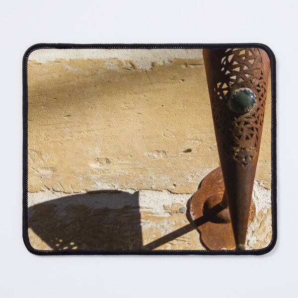 Item preview, Rusted Decorative Metal Sconce Casting a Sharp Shadow on Sunlit Stone Wall, Vintage Rustic Texture designed and sold by Nmallia.