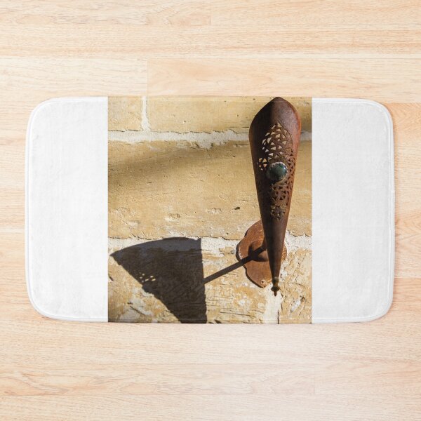 Item preview, Rusted Decorative Metal Sconce Casting a Sharp Shadow on Sunlit Stone Wall, Vintage Rustic Texture designed and sold by Nmallia.