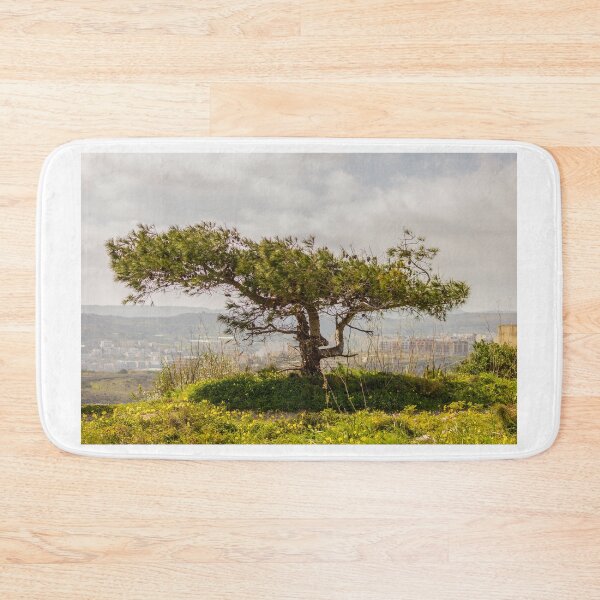 Item preview, Windswept Lone Tree on a Green Hillside Overlooking Distant Town and Valleys Under Cloudy Sky designed and sold by Nmallia.