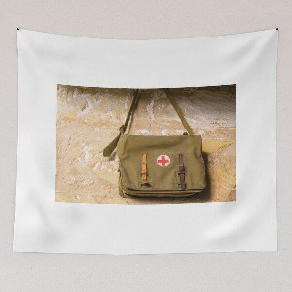 Item preview, Vintage Red Cross Canvas Medical Bag Hanging on Stone Wall, Military First Aid Satchel designed and sold by Nmallia.