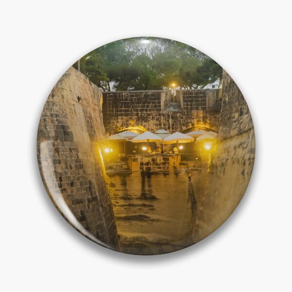 Item preview, Historic Stone Fortress Walls With Lit Terrace Cafe And Narrow Moat At Dusk designed and sold by Nmallia.