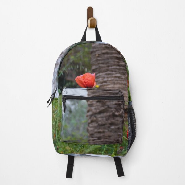 Item preview, Red Poppies Blooming In An Urban Garden Next To A Palm Tree Trunk On A Spring Day designed and sold by Nmallia.