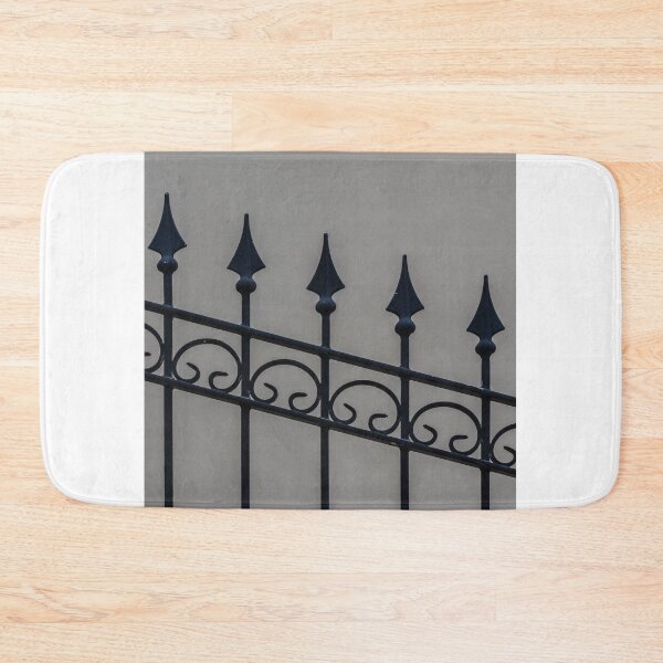 Item preview, Close-Up Of Ornamental Wrought Iron Fence With Pointed Spikes Against Neutral Wall designed and sold by Nmallia.