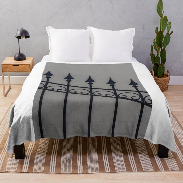 Item preview, Close-Up Of Ornamental Wrought Iron Fence With Pointed Spikes Against Neutral Wall designed and sold by Nmallia.